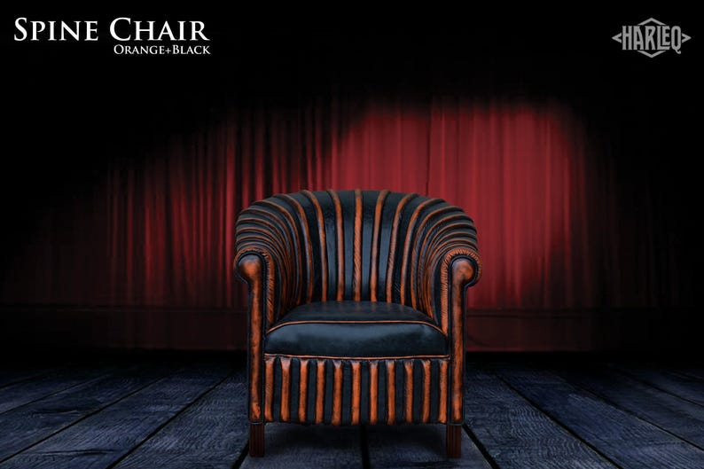 May include: A black and orange striped armchair with a tufted back and seat. The chair is on a wooden floor in front of a red curtain.