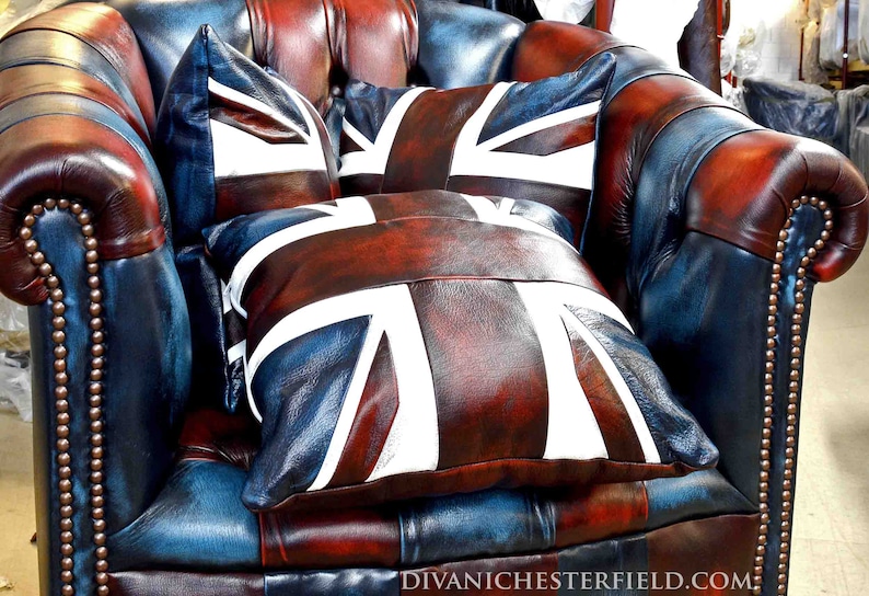 Pu&ograve; includere: Una poltrona in pelle con cuscini con la bandiera Union Jack. La sedia &egrave; un mix di pelle blu, rossa e marrone, con borchie color ottone. I cuscini presentano un disegno Union Jack bianco e rosso.