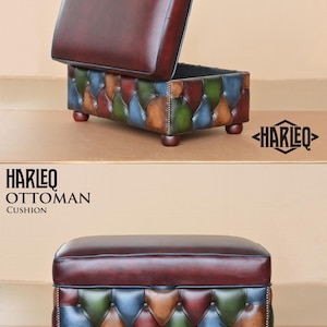 May include: A multi-colored leather ottoman with a tufted top and a hinged lid. The ottoman is made of brown, green, blue, and tan leather. The ottoman is labeled "HARLEQ OTTOMAN CUSHION".