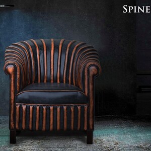 May include: A black leather armchair with orange stitching and a tufted back. The chair has a classic design and is upholstered in a durable leather. The chair is called "Spine Chair" and is available in orange and black.