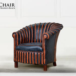 May include: A black and orange leather armchair with a unique, ribbed design. The chair has a rounded back and a comfortable seat. The chair is called "Spine Chair" and is labeled "Orange + Black".