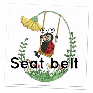 May include: A red and black ladybug on a swing with a yellow flower and green leaves. The text "Seat belt" is below the ladybug.