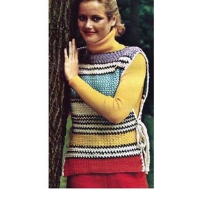 May include: A striped crochet top with a turtleneck and side ties. The top is made in a variety of colors, including white, black, yellow, blue, and purple.