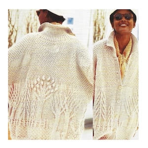 May include: A white knitted cardigan with a button closure and a tree design on the front. The cardigan is shown on a model wearing sunglasses.