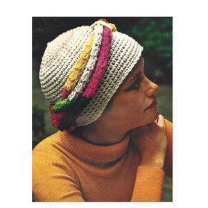 May include: A white crocheted hat with a colorful crocheted band. The band is made of green, yellow, pink, and white yarn.