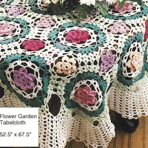 May include: A white crocheted tablecloth with a floral design. The tablecloth features square motifs with pink, purple, and peach-colored flowers, framed by green and white borders. The dimensions are 52.5 inches by 67.5 inches.