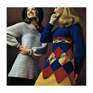 May include: Two women wearing vintage crochet outfits. One woman is wearing a light gray tunic with black and white detailing. The other woman is wearing a blue dress with a red, yellow, and blue geometric pattern.