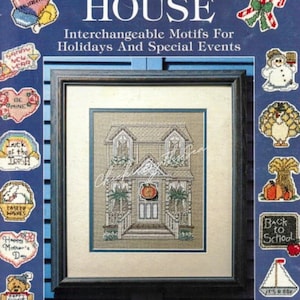 May include: A book cover with the title "Holiday House" and a picture of a house with interchangeable motifs for holidays and special events. The cover features a variety of small cross-stitch designs, including a snowman, a turkey, a pumpkin, a sailboat, and a birthday cake.
