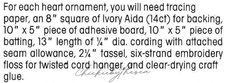 May include: A list of materials needed to make a heart ornament, including tracing paper, ivory Aida fabric, adhesive board, batting, cording, a tassel, embroidery floss, and craft glue.