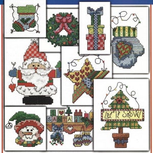 May include: A set of 10 Christmas cross-stitch patterns featuring a variety of festive designs, including Santa Claus, a snowman, a Christmas tree, a wreath, and a star.