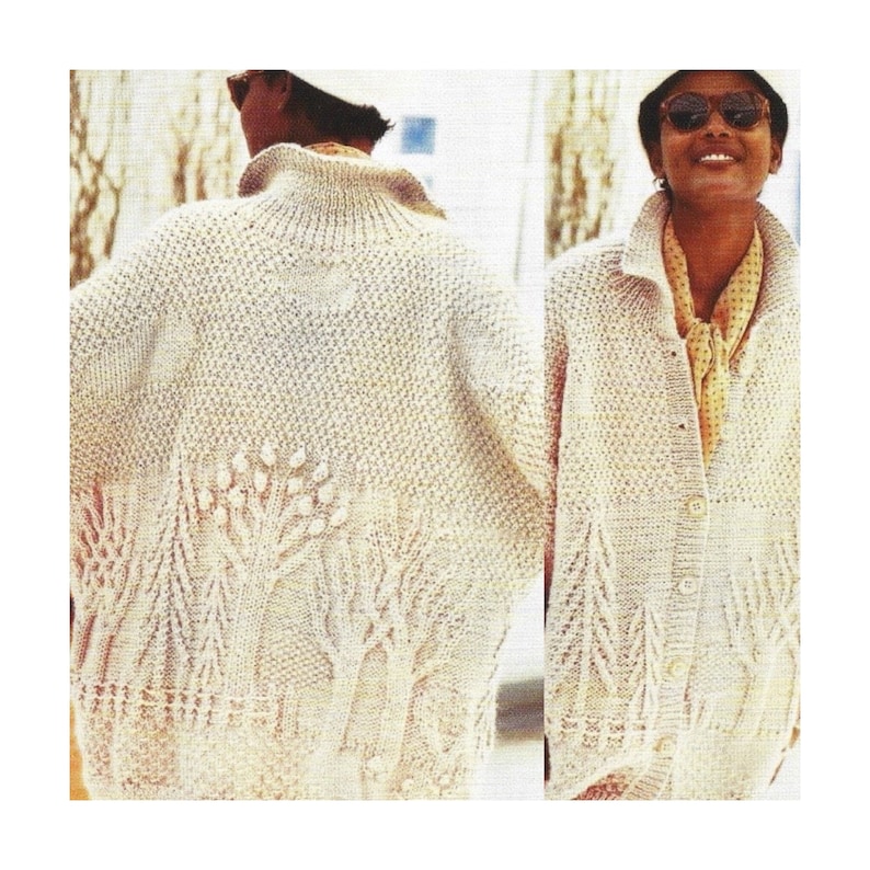 May include: A white knitted cardigan with a button fastening and a tree design on the front. The cardigan is modelled on a person wearing sunglasses.