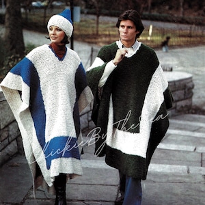 May include: Two people wearing crocheted ponchos, one in white and blue, the other in green and white. The woman is wearing a white crocheted hat.