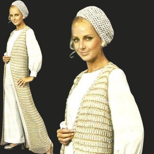 May include: A woman wearing a white crochet hat, a long beige crochet vest, and a white long-sleeve top. The vest has a vertical striped pattern. The outfit is paired with white pants. The background is a solid black.