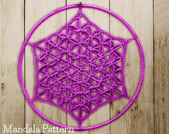 May include: A pink crocheted mandala pattern hanging on a wooden background. The mandala is a geometric design with a flower-like shape.
