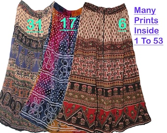 May include: Three long skirts with elastic waistbands and drawstring ties. The left skirt features blue and tan patterns, the middle skirt has a purple and blue tie-dye design, and the right skirt displays red and tan prints. Text reads: Many Prints Inside 1 To 53.