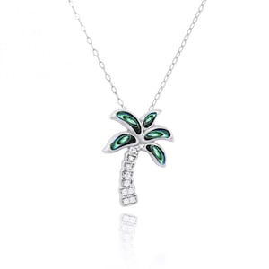 May include: A silver palm tree pendant necklace with green and blue abalone shell inlay and a clear crystal-studded trunk.