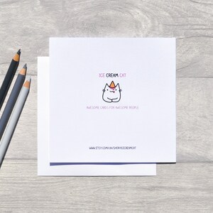 May include: A white card with a cartoon cat wearing a pink and orange ice cream cone hat. The text "ICE CREAM CAT" is above the cat and "AWESOME CARDS FOR AWESOME PEOPLE" is below the cat. The text "www.etsy.com/uk/shop/icecreamcat" is at the bottom of the card.