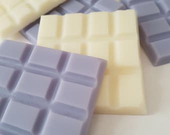 May include: A set of wax melts in two colors: lavender and white. The wax melts are in a rectangular shape with a grid pattern.