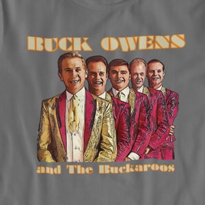 May include: A gray t-shirt with a vintage-style image of a band called "Buck Owens and The Buckaroos". The band members are wearing red and gold suits and are smiling.