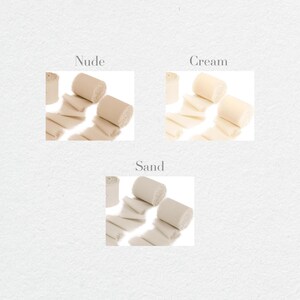 May include: Three rolls of fabric ribbon in different shades of beige: nude, cream, and sand. The ribbon is made of a soft, natural material and has a slightly textured surface.