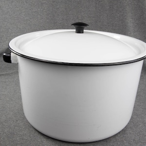 May include: White enamelware pot with a black rim and lid. The lid has a black knob.