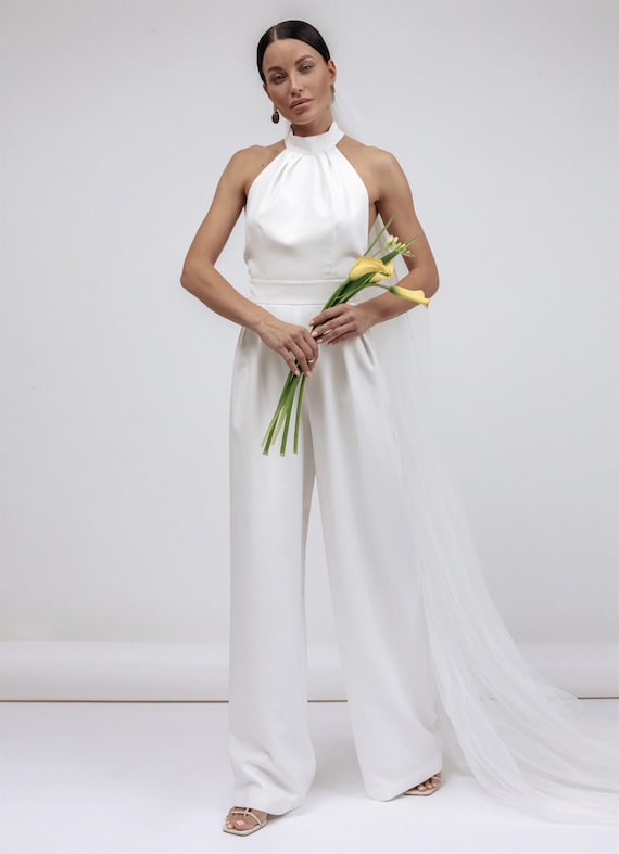 Women's white jumpsuit with an open back made of dense satin