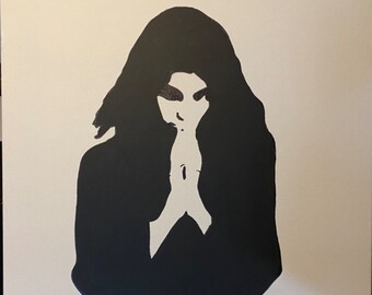 May include: A black and white silhouette painting of a person with long hair, standing with their hands clasped in front of them.