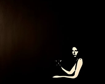 May include: A black and white silhouette of a person sitting with their arm resting on a chair. The person's face is visible and they are looking to the side.