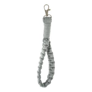 May include: A gray macrame wrist strap with a silver-colored clasp. The strap is made of braided cord and is designed to be attached to a keychain or other small items. The wrist strap is a neutral color and can be used by anyone.