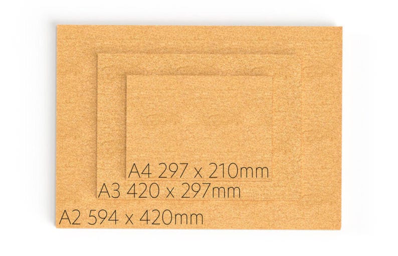 May include: Three rectangular tan cork sheets stacked in descending size order. The sheets are labeled with black text: A4 297 x 210mm, A3 420 x 297mm, and A2 594 x 420mm. Each sheet features a natural, granular, and textured surface.