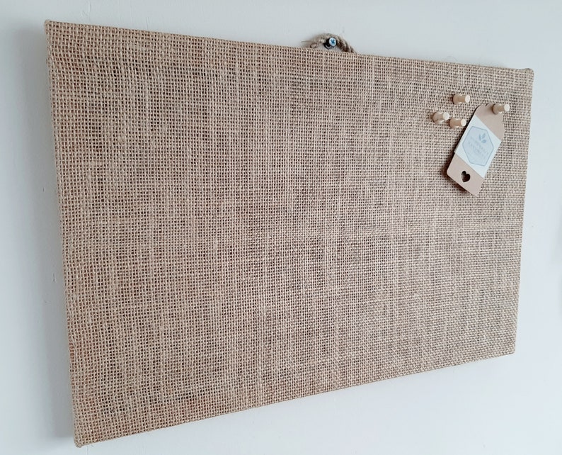 cork board covered in hessian fabric.