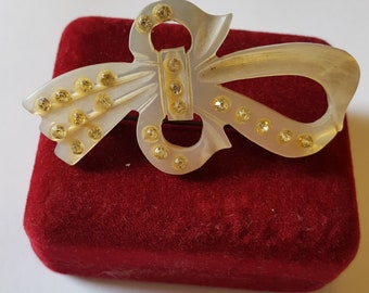 Vintage hand carved mother of pearl bow brooch.