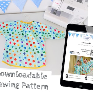 May include: A downloadable sewing pattern for an art smock. The pattern features a colorful polka dot design on a light blue background. The pattern is available as a digital download and includes a video tutorial.
