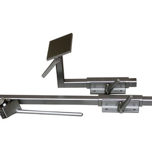 May include: A pair of silver metal adjustable seat brackets with a lever to lock the seat in place. The brackets are designed to be mounted to a wall or other surface.