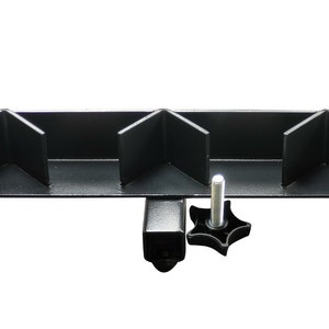 May include: Black metal corner brace with four angled slots and a clamp with a star-shaped knob.