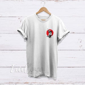 May include: White t-shirt with a black and white illustration of a samurai warrior standing in front of a red sun.