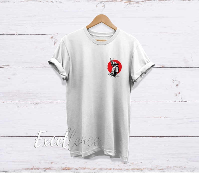 May include: White t-shirt with a black and white illustration of a samurai warrior standing in front of a red sun.
