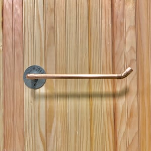 Copper pipe wall mounted paper towel holder. This photo is a right side feed. Please state if you need a right or left side feed.