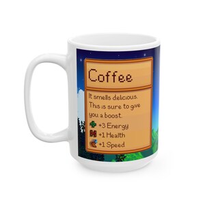 May include: White ceramic coffee mug with a pixelated design featuring a coffee item card from the video game Stardew Valley. The card reads "Coffee" and lists the following stats: "It smells delicious. This is sure to give you a boost. +3 Energy +1 Health +1 Speed"