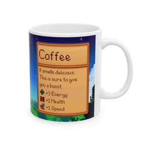 May include: White ceramic mug with a pixelated image of a coffee item from the video game Stardew Valley. The image shows a brown wooden box with the text "Coffee" in orange letters. The box contains text that reads "It smells delicious. This is sure to give you a boost." and a list of stats: +3 Energy, +1 Health, +1 Speed.