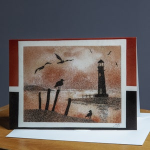 Carte de vœux A5, reproduction du tableau de sable "Phare et oiseaux au coucher de soleil"