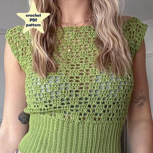 May include: A green crochet top with an openwork design. The top features a fitted waist and cap sleeves. The image includes text that says "crochet PDF pattern".