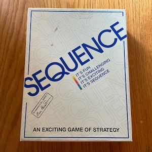 May include: A white box with the word "SEQUENCE" in blue letters. The box has a rainbow colored stripe and the text "IT'S FUN, IT'S CHALLENGING, IT'S EXCITING, IT'S SEQUENCE" in black letters. The box also has the text "AN EXCITING GAME OF STRATEGY" in black letters.