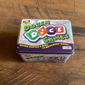 May include: A purple and green tin box with the words "Dozen Dice Games" and "Shake Rattle & Roll 12 Different Ways!" printed on it. The box contains a game with dice.