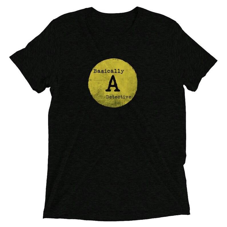 May include: Black t-shirt with a yellow circle graphic that says "Basically A Detective" with a large letter "A" in the center.