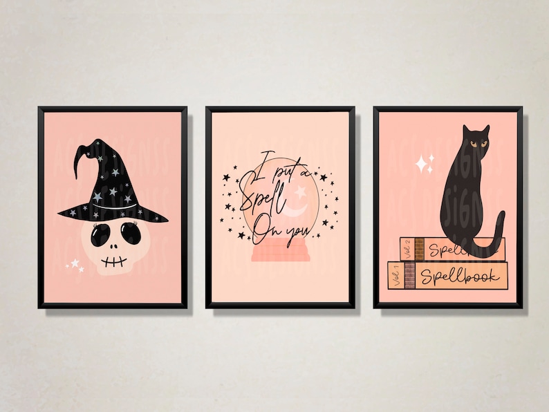 May include: Three printable wall art prints with a pink background. The first print features a black and white illustration of a skull wearing a witch's hat. The second print features a black and white illustration of a crystal ball with the text "I put a spell on you." The third print features a black cat sitting on top of three books with the text "Spellbook".