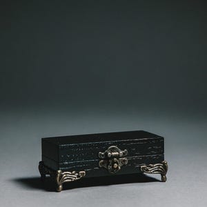 Bring sophistication to your wedding day with this black wooden ring box.