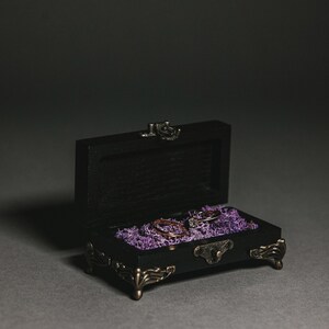 Made from durable wood, with detailed metal legs and a lock, ensuring both beauty and longevity.