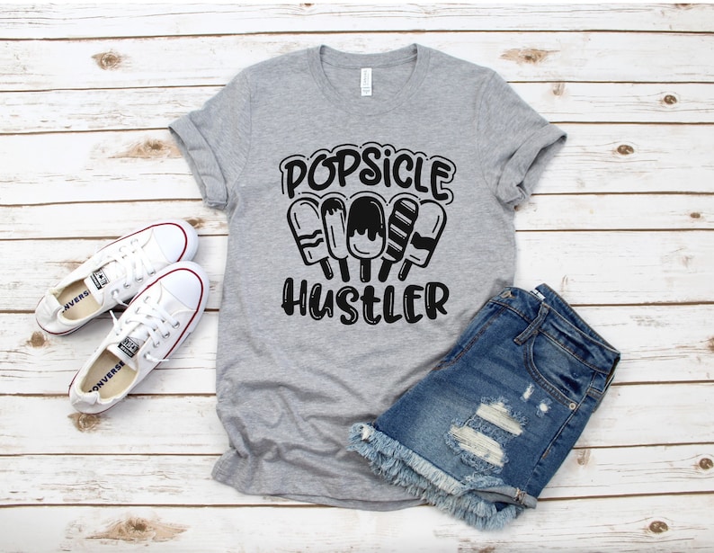 May include: Gray t-shirt with the text "Popsicle Hustler" and a graphic of four popsicles.