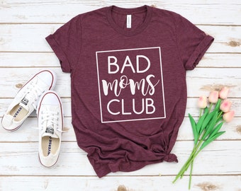 May include: A maroon t-shirt with the text "BAD moms CLUB" in a white box.